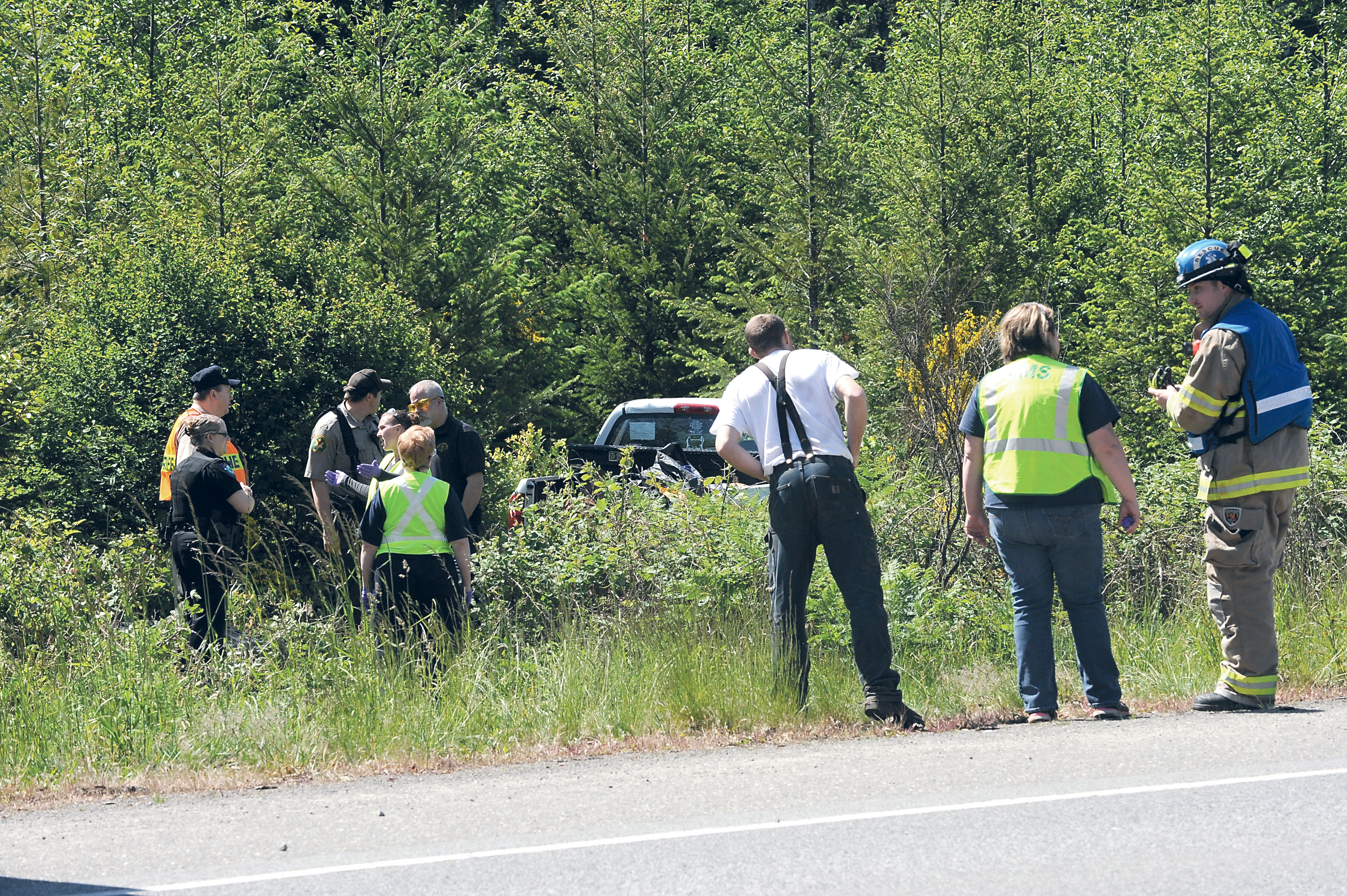 Emergency responders at the scene where a truck left U.S. Highway 101 near Beaver this week. Lonnie Archibald/for Peninsula Daily News