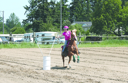 Zoe Thompson successfully plants a flag inside the barrel during Saturday's Patterned Speed Horse Association show at the Quarter Moon Ranch in Carlsborg. Thanks to Grandma Marie Dickinson