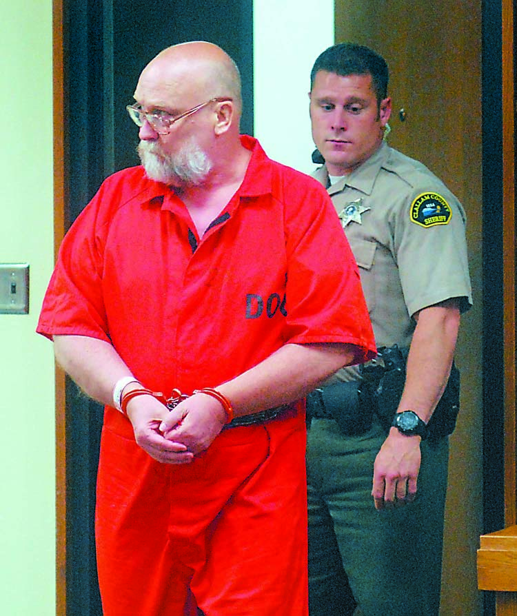 Darold Stenson enters Clallam County Superior Court for a status hearing last July accompanied by court security officer Eric Morris. Keith Thorpe//Peninsula Daily News