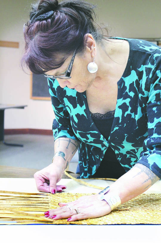 Polly DeBari works on fishing-tackle pouch for the upcoming Makah Museum exhibit