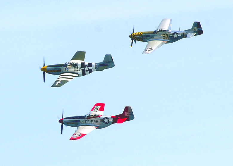 A trio of vintage P-51 Mustangs flies in a “V” formation during a flyover of Port Angeles on Friday morning. The flight