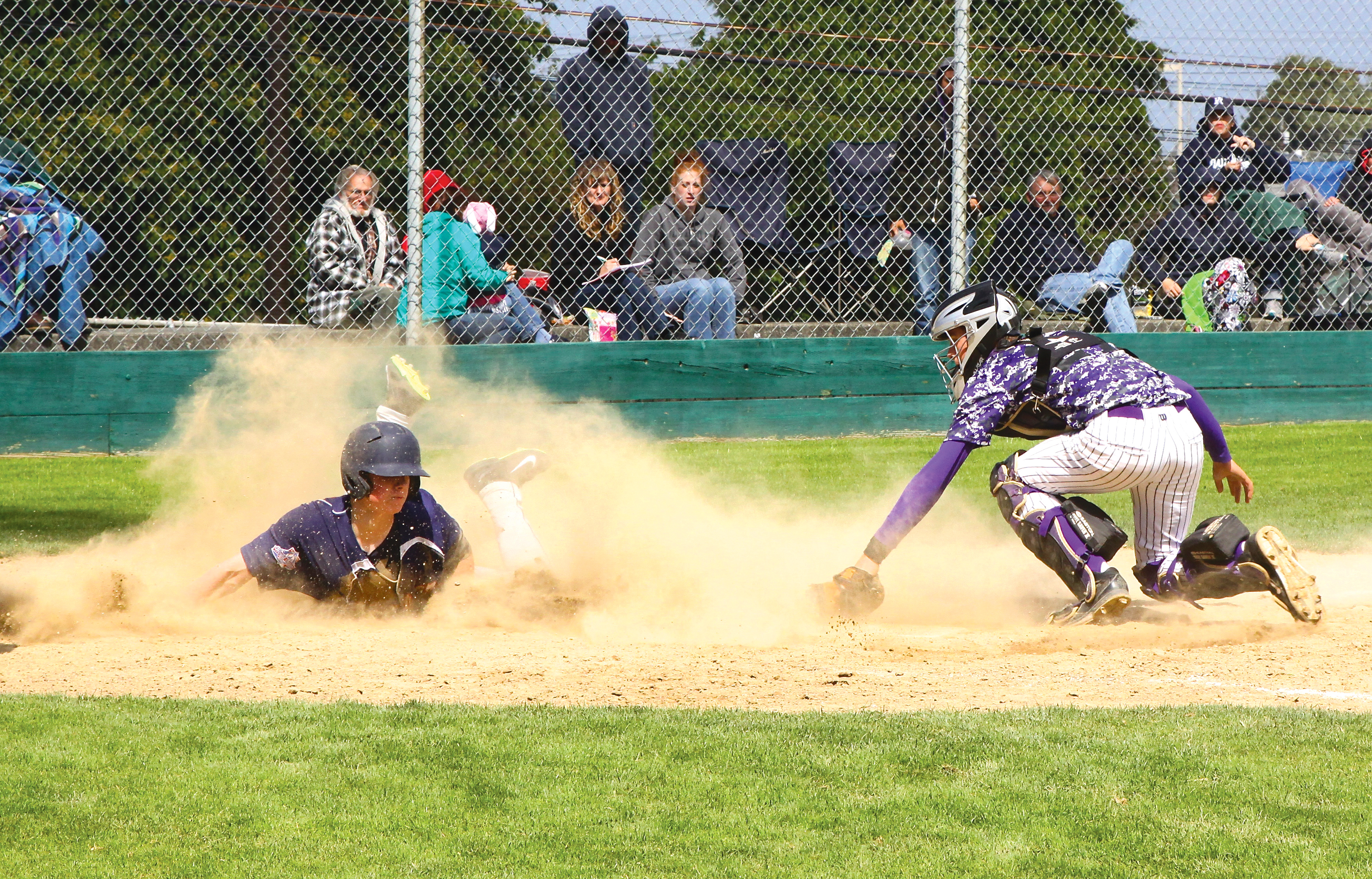 Wilder's Tanner Gochnour scores in a cloud of dust at home plate