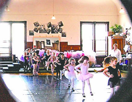 Young tap dancers can be seen through a window practicing recently at the O'Meara Dance Studio. More than 130 dance students will perform tonight and Saturday in Port Townsend. O'Meara Dance Studio