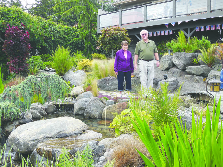 Bill and Nancy Helwick stand surrounded by their garden