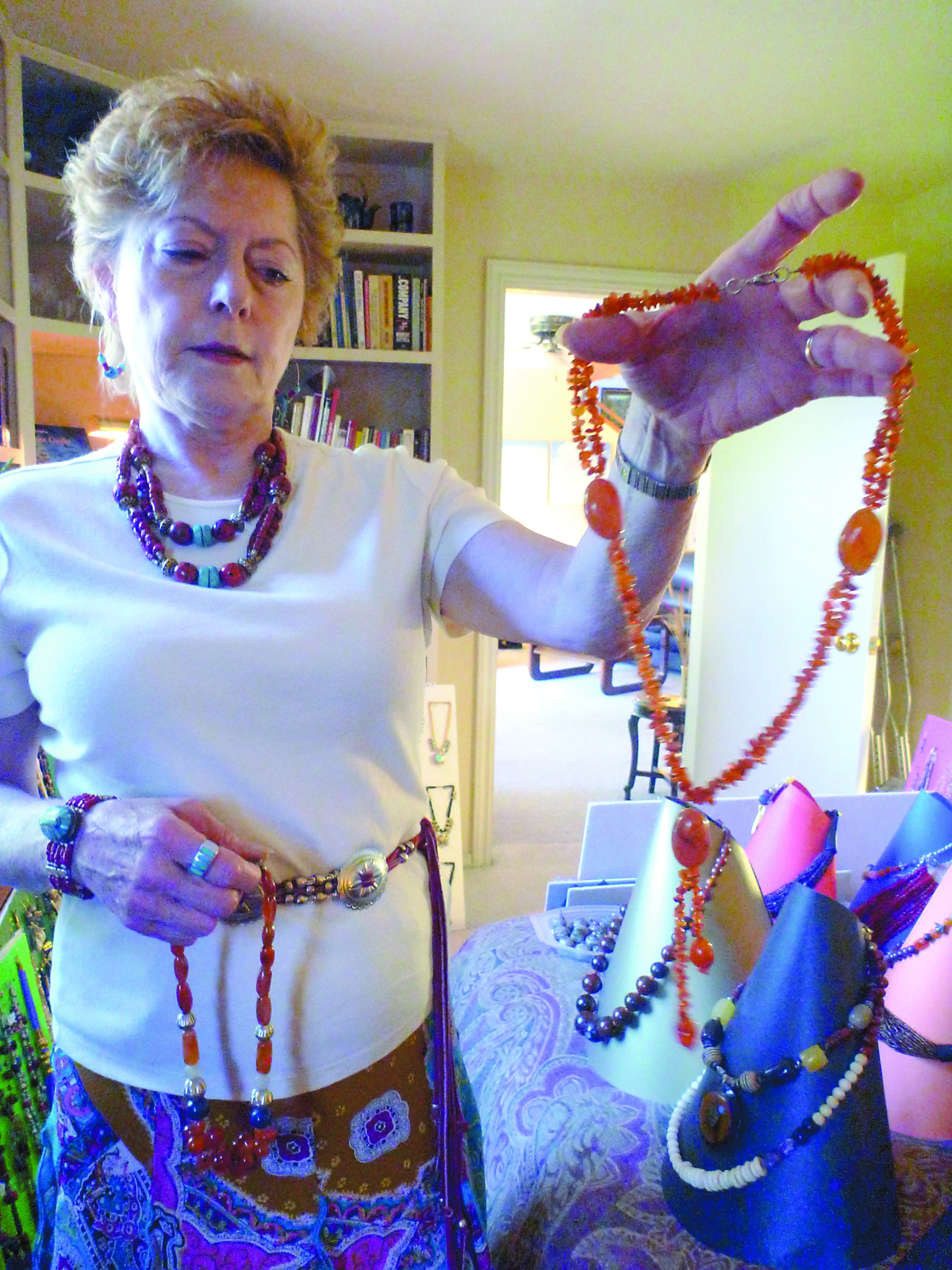 Sarah DuBose holds up a necklace made of carnelian