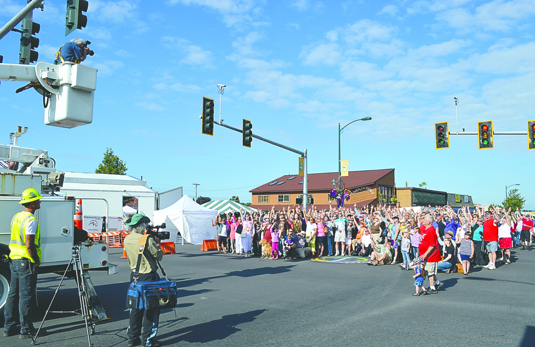 Photographer Ernest-Ulrich Shafer takes a photo at the intersection of Washington Street and Sequim Avenue on Friday in downtown Sequim. Joe Smillie/Peninsula Daily News