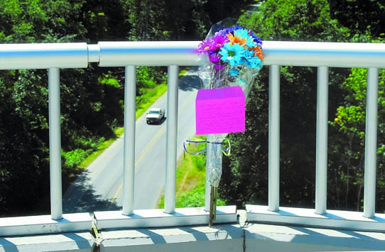 Flowers are tied to the west Eighth Street Bridge in Port Angeles