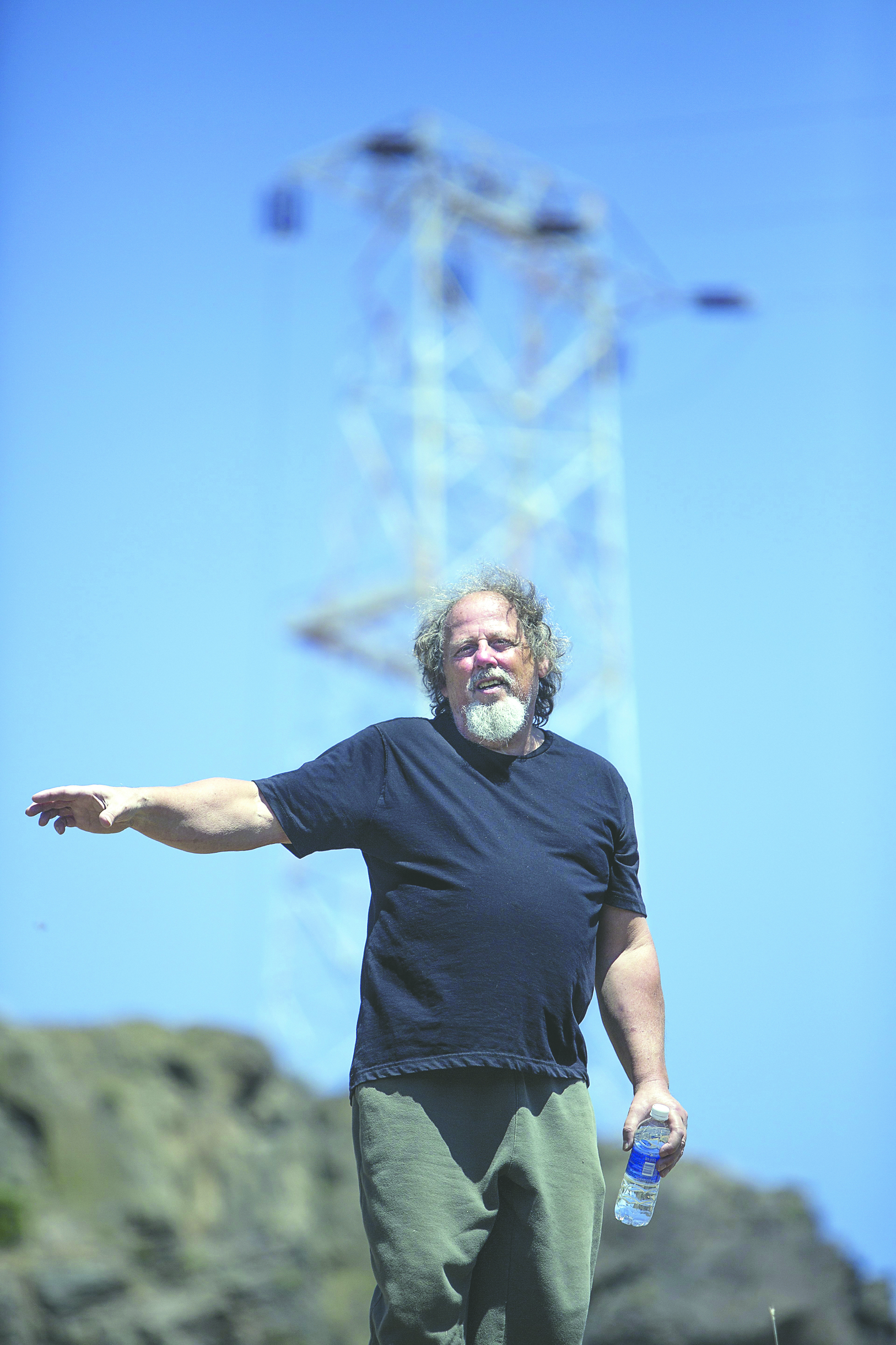 Robert Zornes stands on his property near the transmission tower that BPA wants to replace. Steve Ringman/The Seattle Times