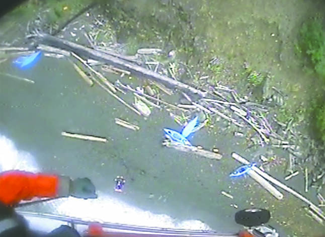 A shot from a Coast Guard video shows an aerial view of the kayaks from which nine people were rescued Thursday near Rosario Beach on Fidalgo Island south of Anacortes. Coast Guard