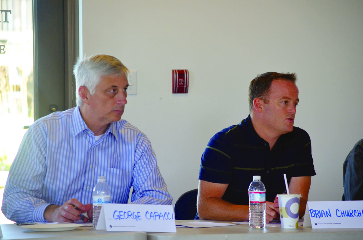 George Capacci listens to Brian Churchwell explain the lessons learned from the rollout of the new ferry reservations system at a meeting in Port Townsend. Charlie Bermant/Peninsula Daily News