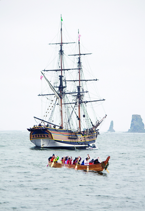 A tribal canoe passes by the Lady Washington along the coast during the tribal canoe journey. Jaclyn Peterson
