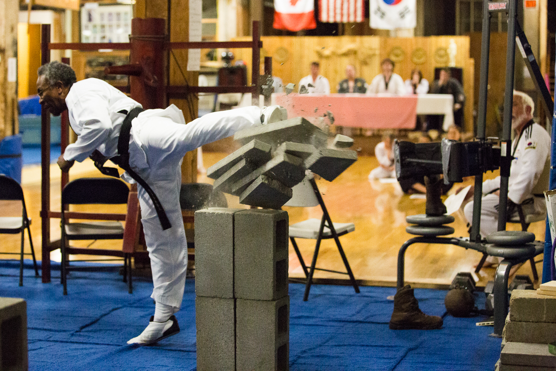 Taekwondo instructor Sterling Chase breaks five bricks with a speed kick during martial arts testing at White Crane Martial Arts in Port Angeles. Chase tested for the high rank of seventh dan