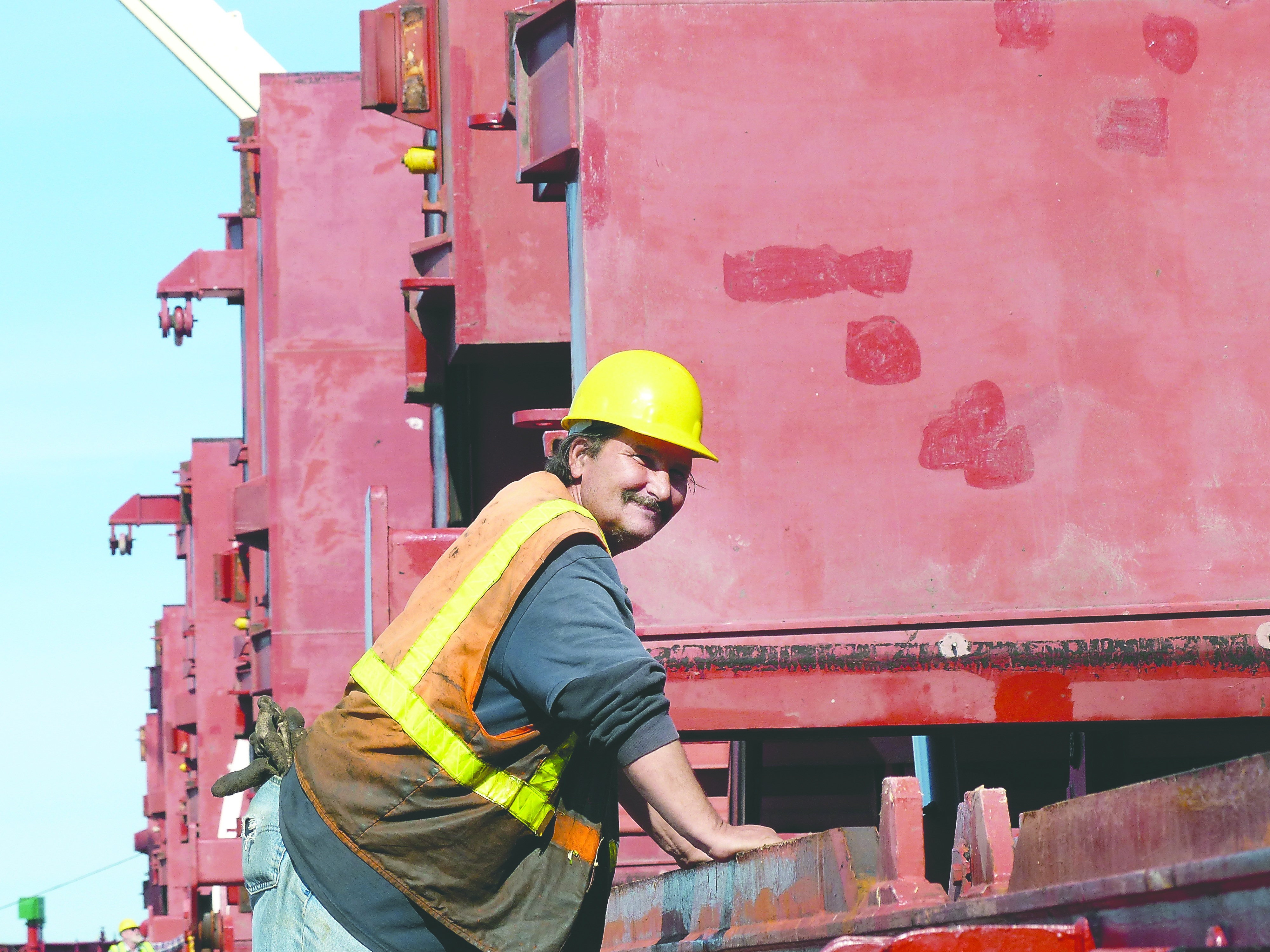Longshoreman Jim Giulietti of Port Angeles oversees the stowing of logs in a hold aboard the STX Rapido. -- Photo by David G. Sellars/Peninsula Daily News