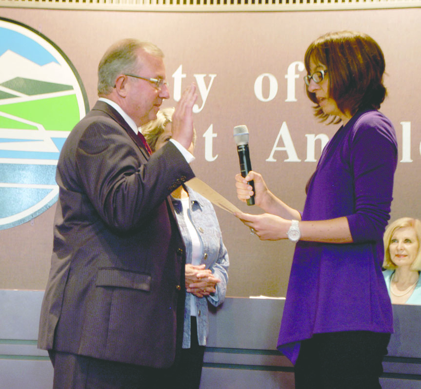 Dan Gase is sworn in by Port Angeles City Clerk Janette Hurd as Gase's wife
