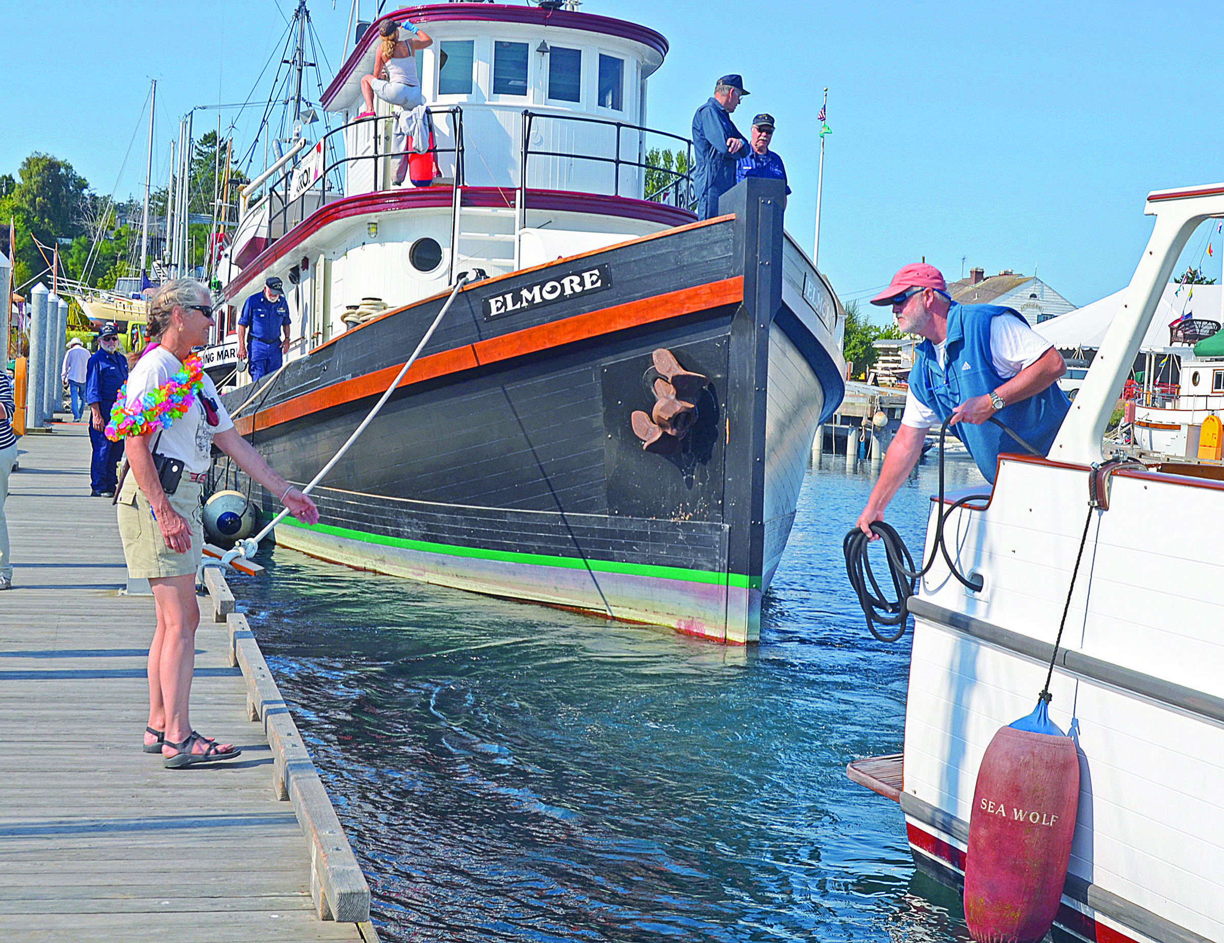 Kim Aldrich waits for a mooring rope to be tossed from a guest boat as boats trickle into Point Hudson Marina for the Wooden Boat Festival in 2011. Charlie Bermant/Peninsula Daily News