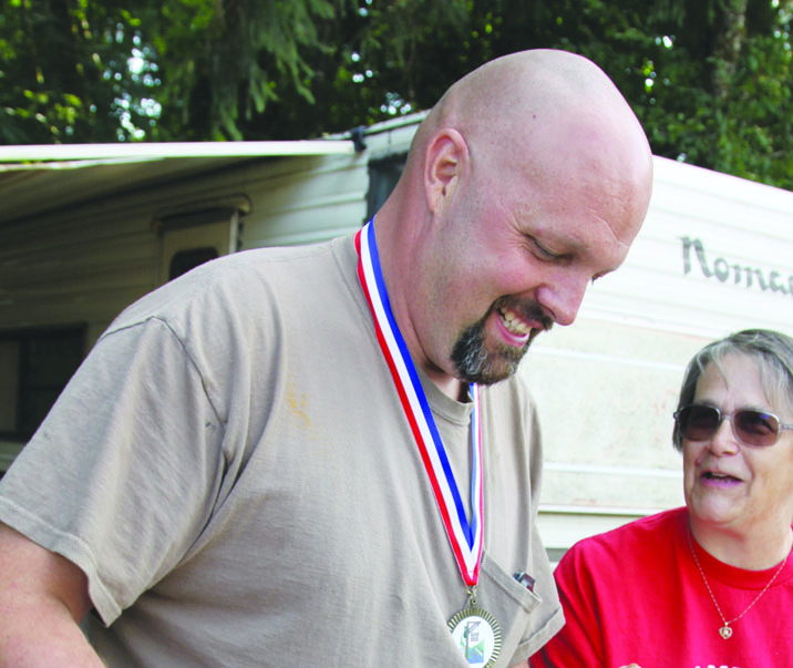 Don Bedinger of Carlsborg serves up some of his winning chili to Nancy Slowey of Port Angeles on Saturday. Dave Logan
