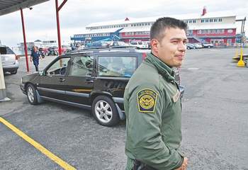 Border Patrol Agent Christian Sanchez stands outside the Black Ball ferry terminal in Port Angeles in September 2011. Peninsula Daily News