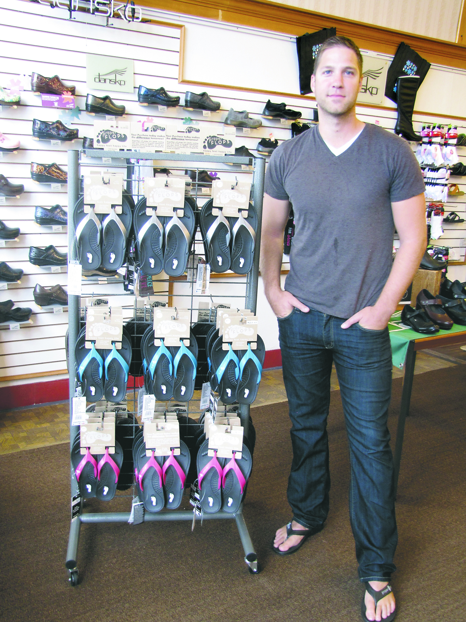 George Peterson stands with a display of his Proper Flops sandals at Family Shoe Store in Port Angeles. Arwyn Rice/Peninsula Daily News