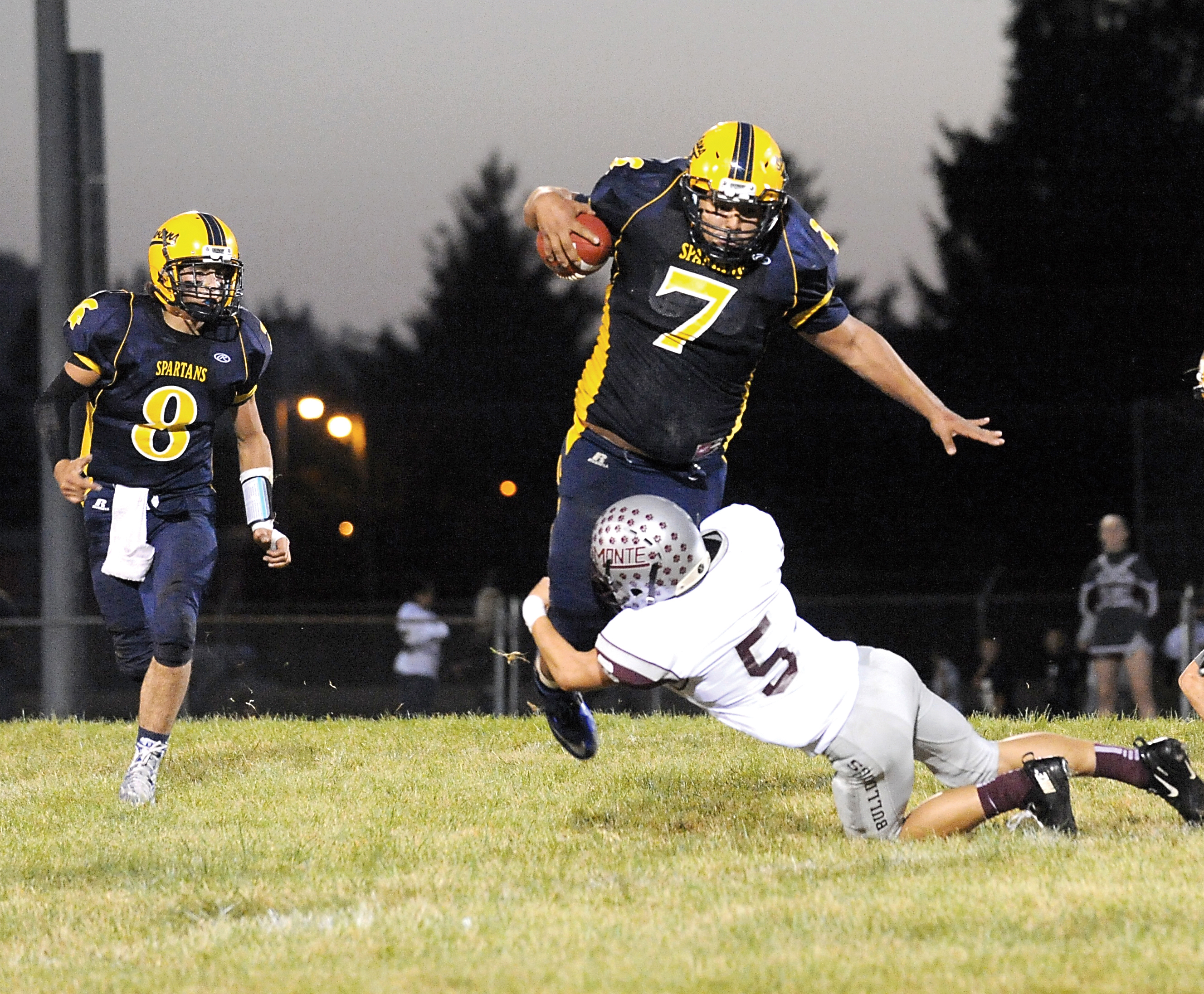 Forks running back Miguel Morales (7) is brought down by Montesano's Logan Truax. Also in on the action is Forks quarterback Javier Contreras (8). Lonnie Archibald/for Peninsula Daily News