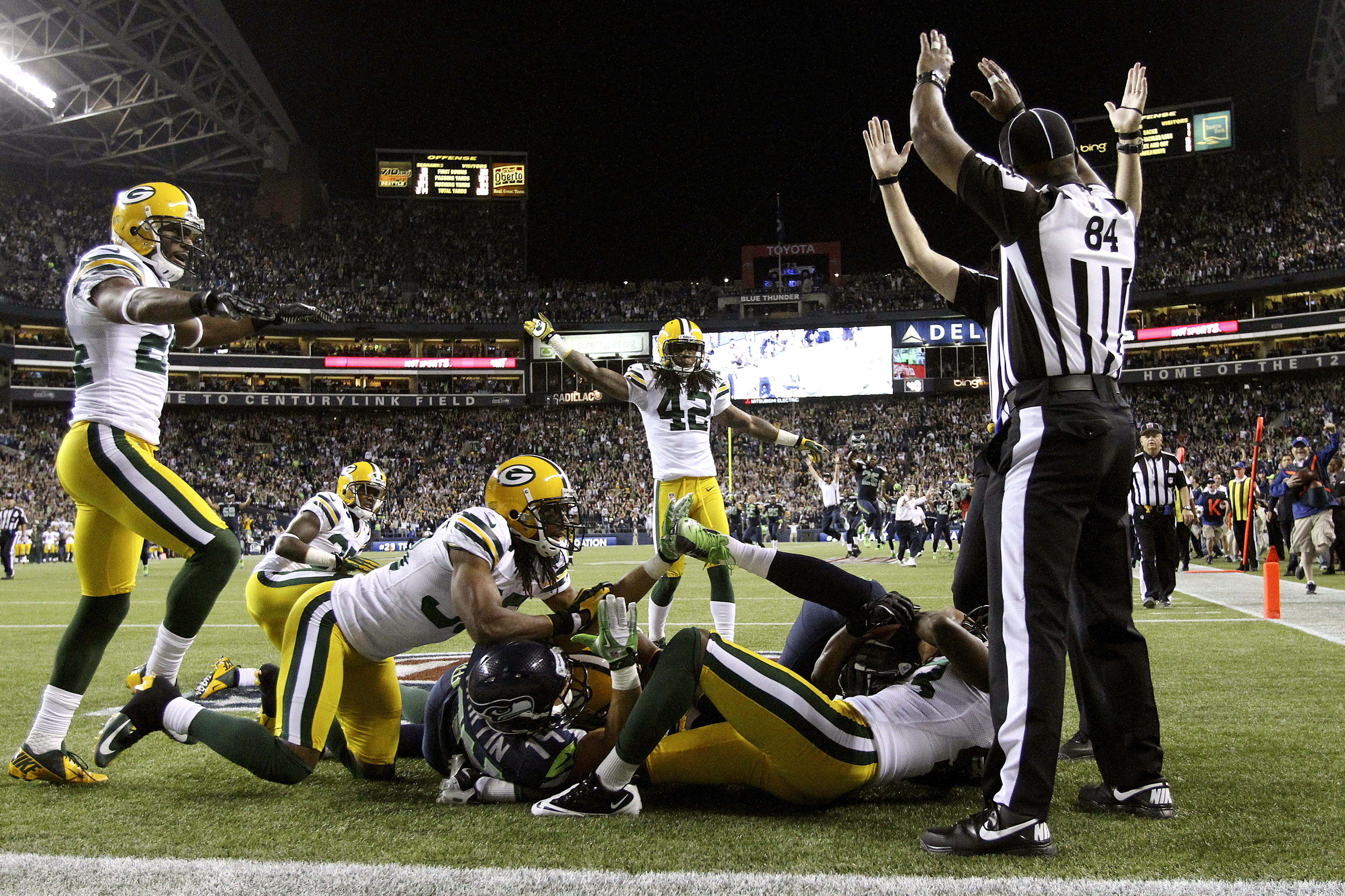 Referees signal different calls after Monday night's game-ending play. It was finally ruled a touchdown