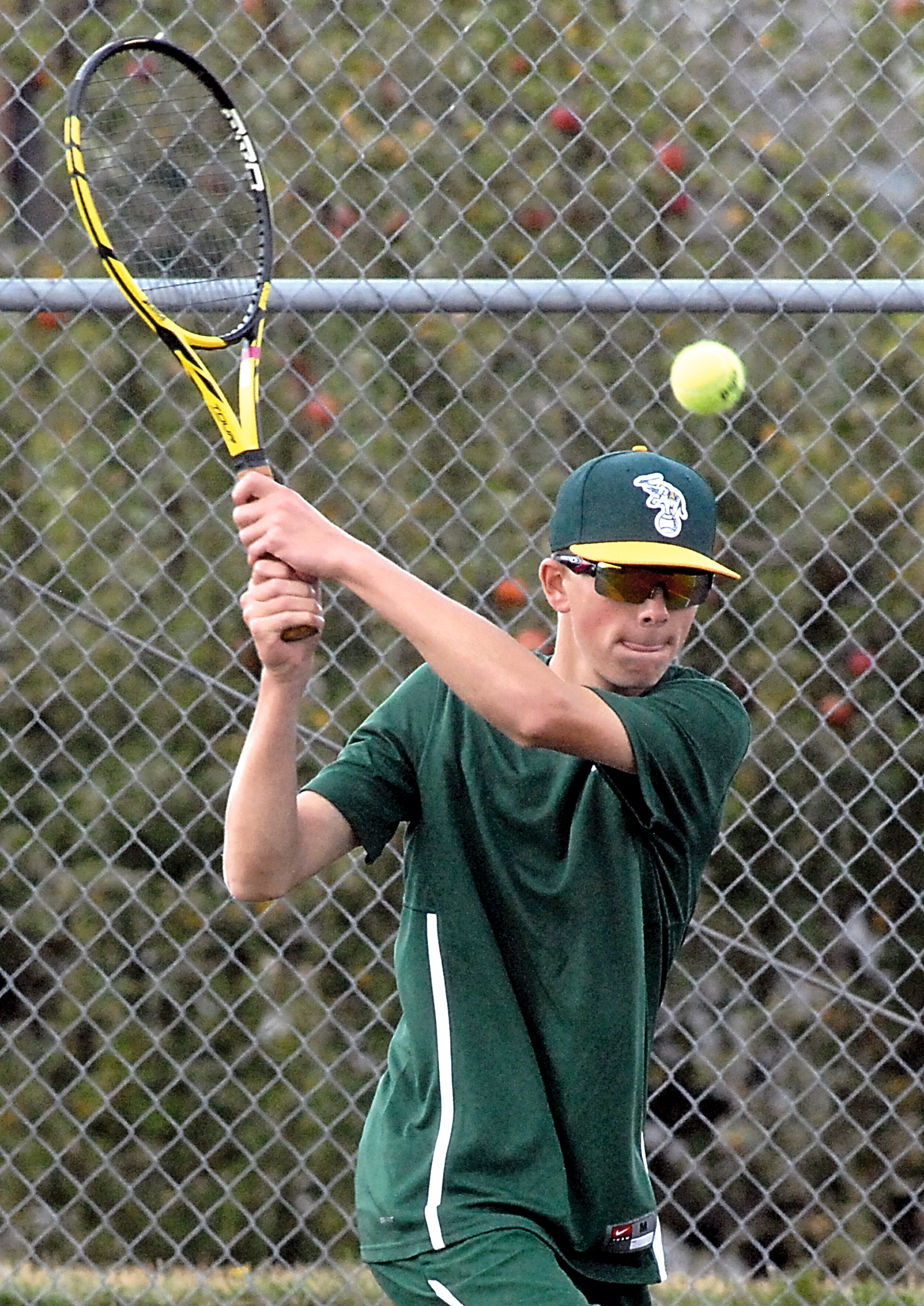 Port Angeles' Janson Pederson hits a return during his singles match against Kingston's Spencer Bowlus at Port Angeles High School. Keith Thorpe/Peninsula Daily News