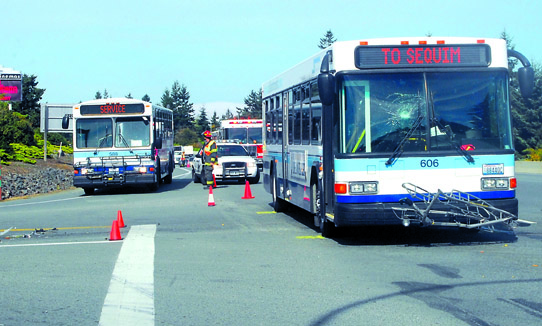 A bus sits with a shattered windshield after a hit-and-run accident Wednesday morning on U.S. Highway 101 near Deer Park Road. Keith Thorpe/Peninsula Daily News