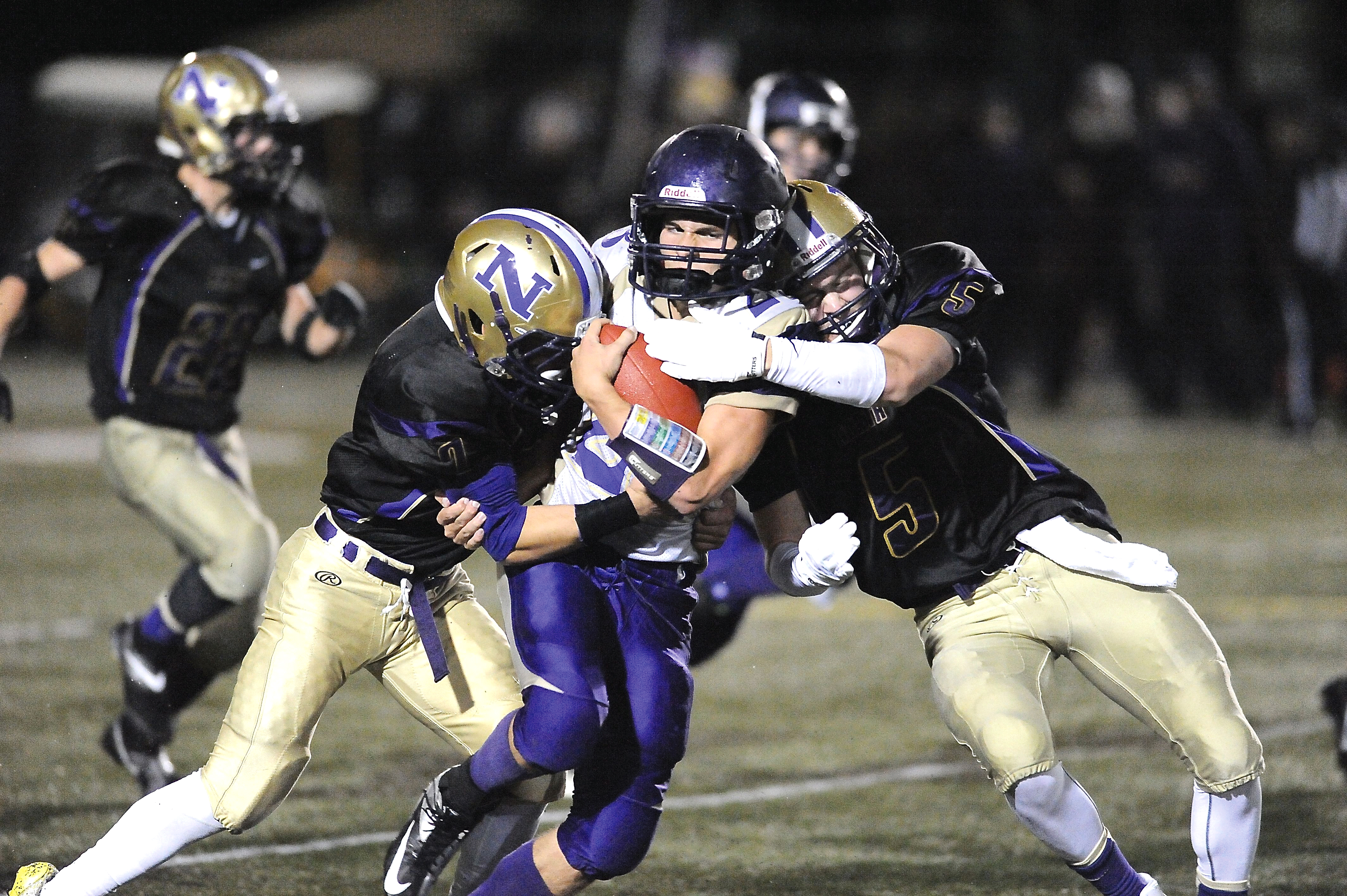 Sequim's Ty Jones is stopped by North Kitsap's Leif Klinger