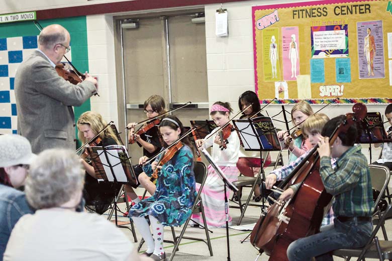 Instructor Phil Morgan-Ellis leads students in the Sequim Community Orchestra's Strings in the Schools program. Christopher Tadlock