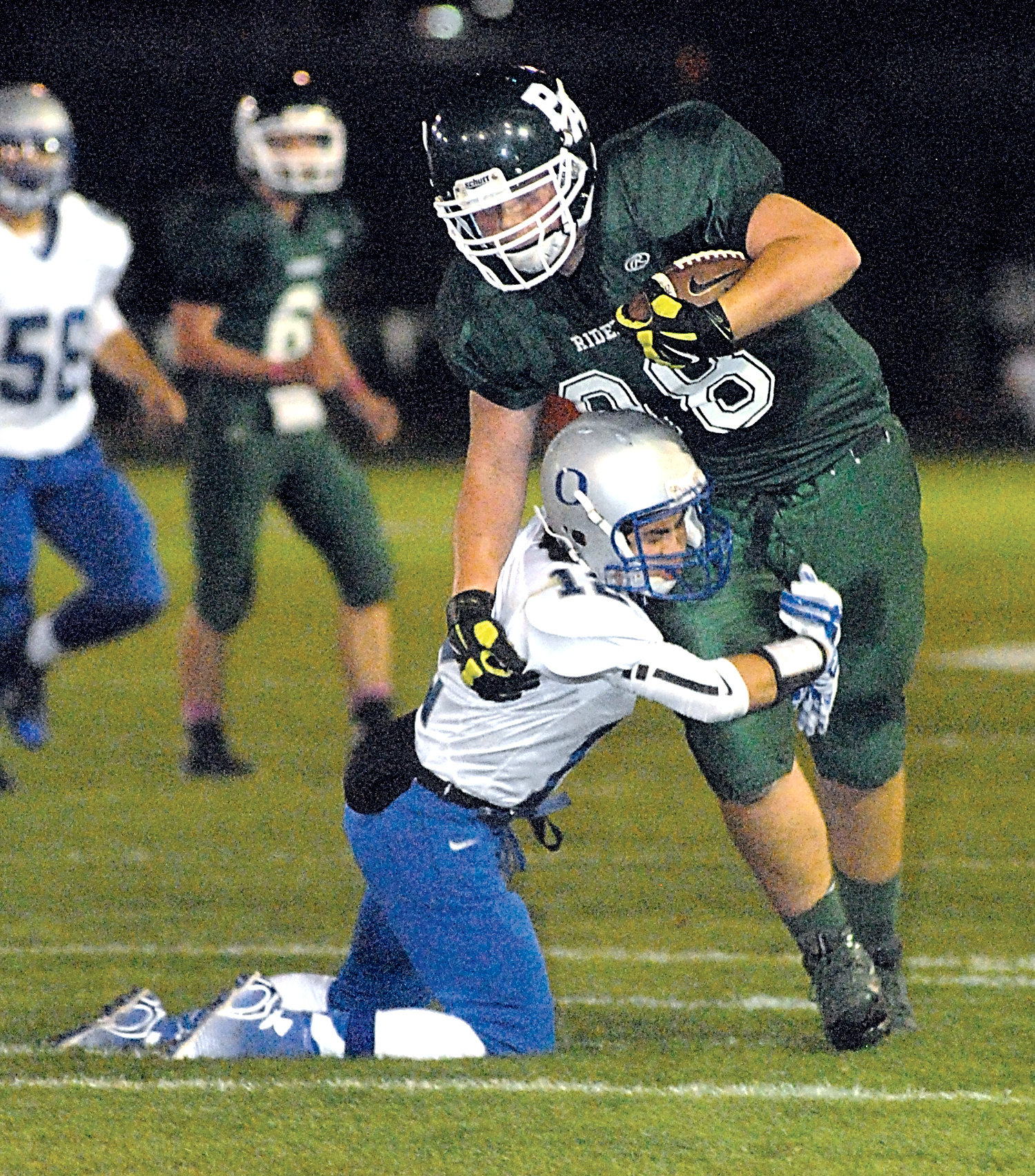 Port Angeles' John Boesenberg tries to elude the tackle of Olympic's Ethan Goldizen at Civic Field. Boesenberg picked up 11 yards on the play. Keith Thorpe/Peninsula Daily News