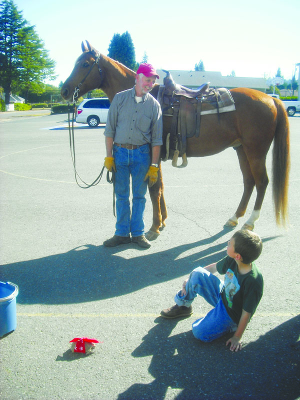 Mike Perry with his horse Murphy waits with Connor Burnette