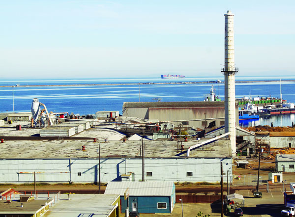 The buildings and smokestack of the old Peninsula Plywood mill in Port Angeles will start coming down in November. Dave Logan/for Peninsula Daily News