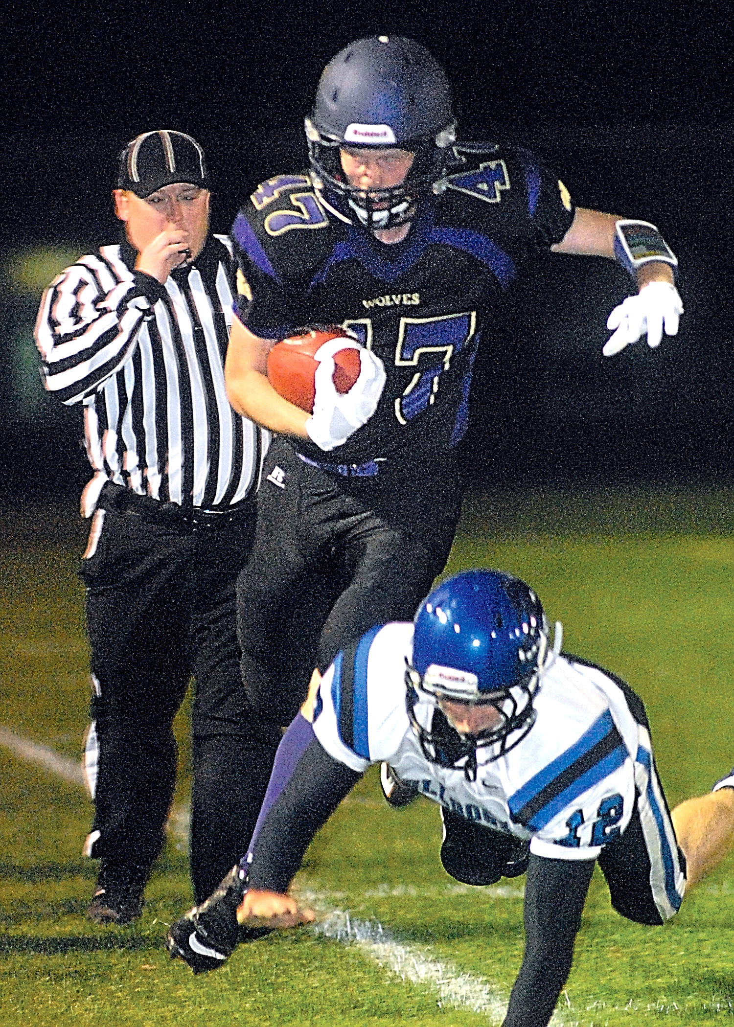 Sequim's Chris Frick gets knocked out of bounds by North Mason's Matt Becker during the second quarter of the Wolves' 26-20 overtime win. Keith Thorpe/Peninsula Daily News