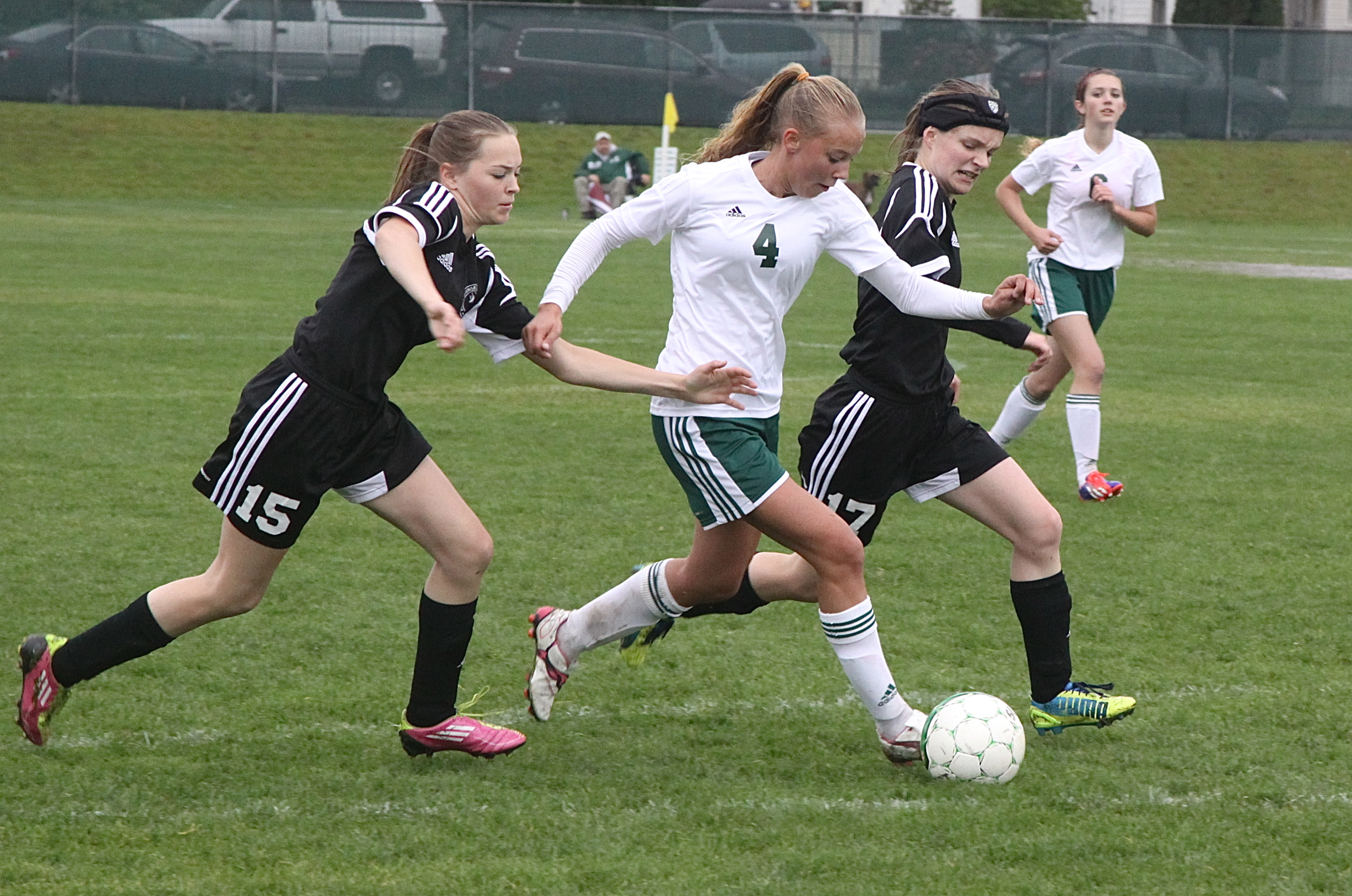 Port Angeles' Maddie Boe (4) contends with Port Townsend's Anne Meek (15) and Rebecca Stewart (17) for possession of the ball. Dave Logan/for Peninsula Daily News