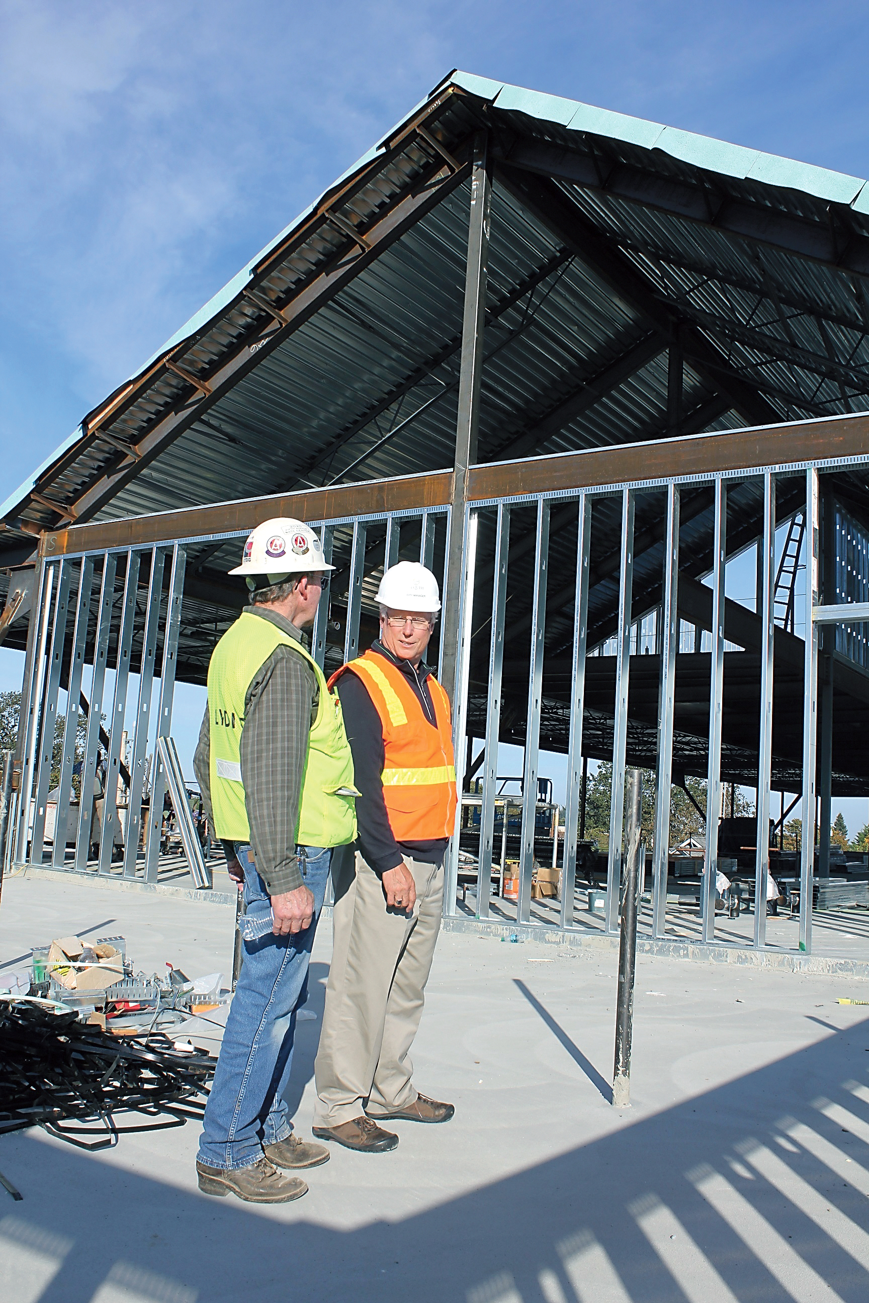 Lydig Construction project manager Ed Griffin and Sequim City Manager Steve Burkett discuss the construction progress on Sequims new civic center during a tour of the complex. Photo by Mark St.J. Couhig/Peninsula Daily News