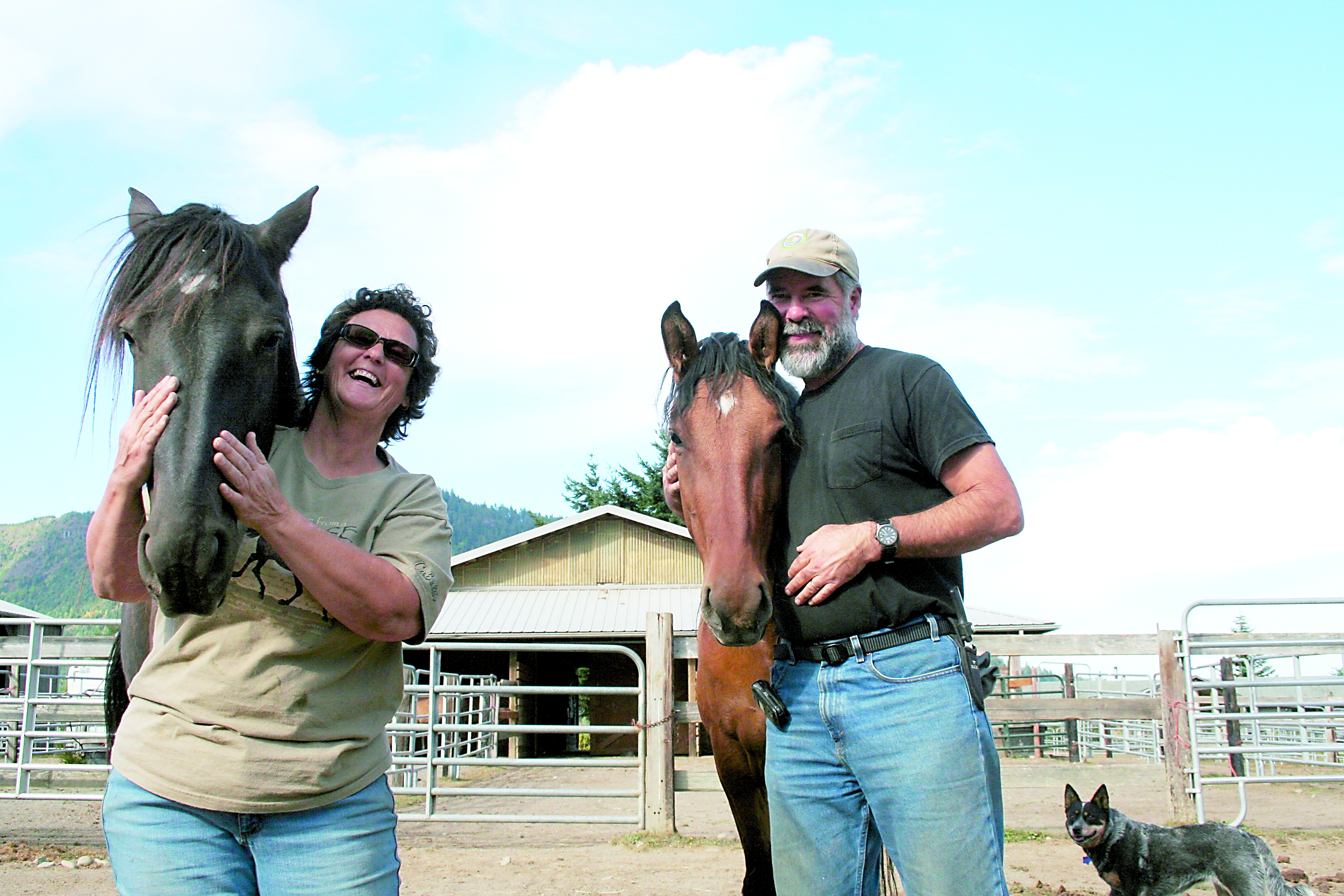Spirit Horse Ranch owners Becky and Dave Seibel are shown with two of their six Bureau of Land Management mustangs