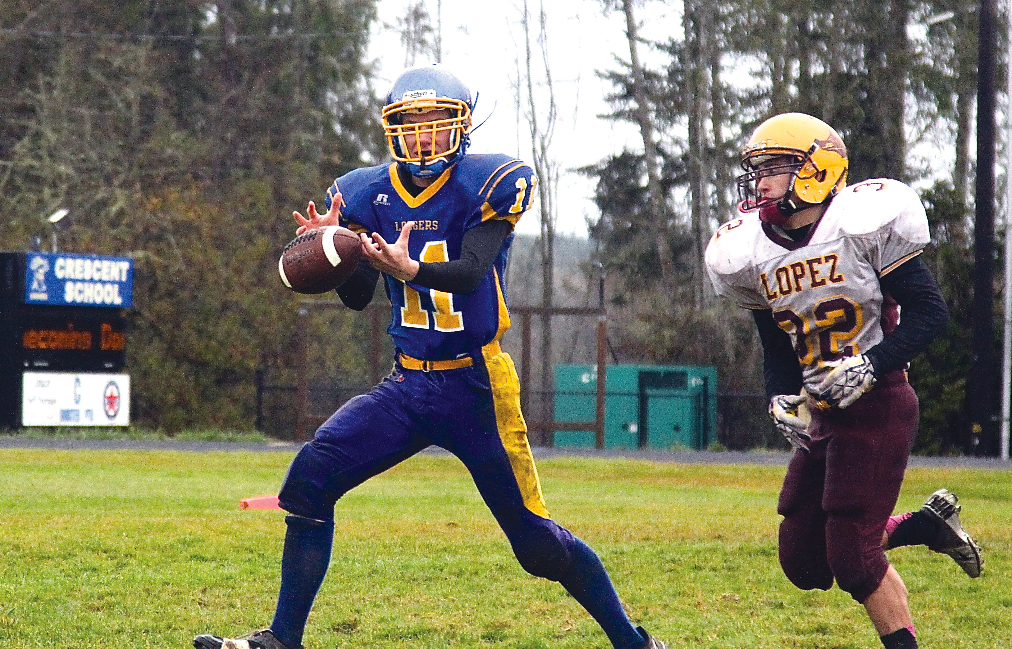 Crescent receiver Martin Waldrip (11) just misses a pass as Lopez defender Harrison Goodrich (32) closes in. The Loggers ended their season with a 56-6 loss. Dave Logan/for Peninsula Daily News