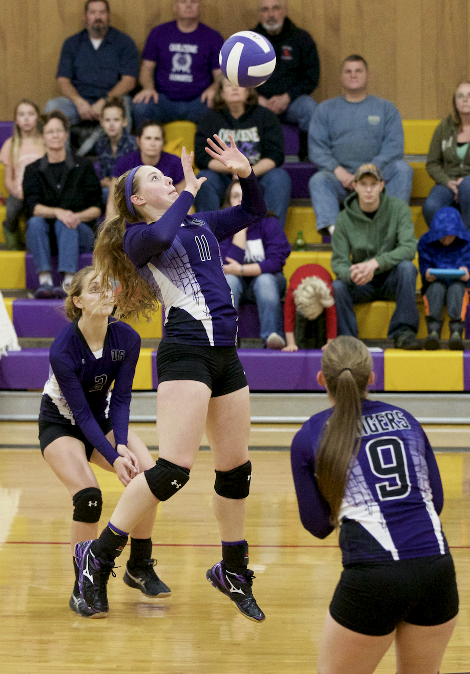 Quilcene's Megan Weller (11) sets the ball for a spike by Allison Jones (9) as Katlin Hitt (3) gets ready to back up the play during the Rangers play-in game win over Shoreline Christian. Steve Mullensky/for Peninsula Daily News