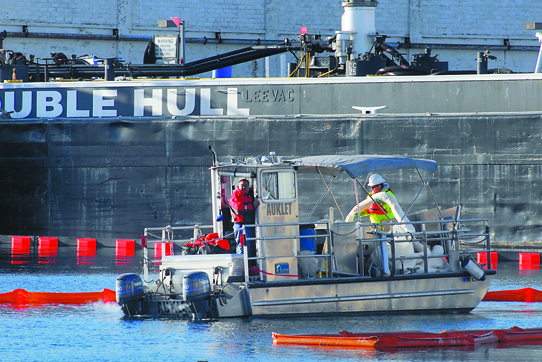 An oil spill response boat works next to a fuel barge at the west end of Port Angeles Harbor on Wednesday after fuel was spilled into the harbor. Keith Thorpe/Peninsula Daily News