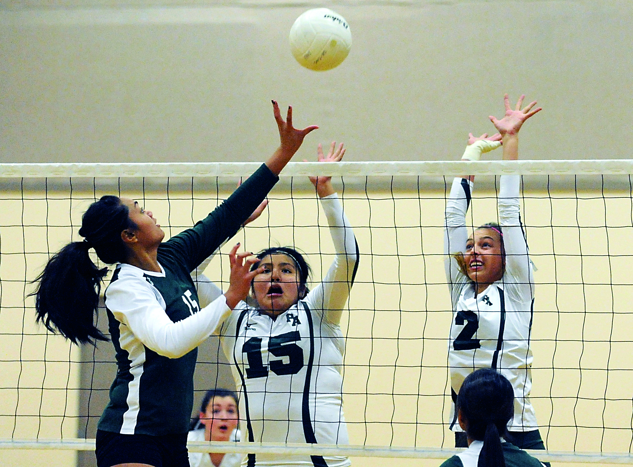 Port Angeles' Nizhoni Wheeler (15) and Maddy Hinrichs (2) attempt to block a hit by Evergreen's Mailelei Faletogo (15). The Riders defeated Evergreen 3-2. Lonnie Archibald/for Peninsula Daily News