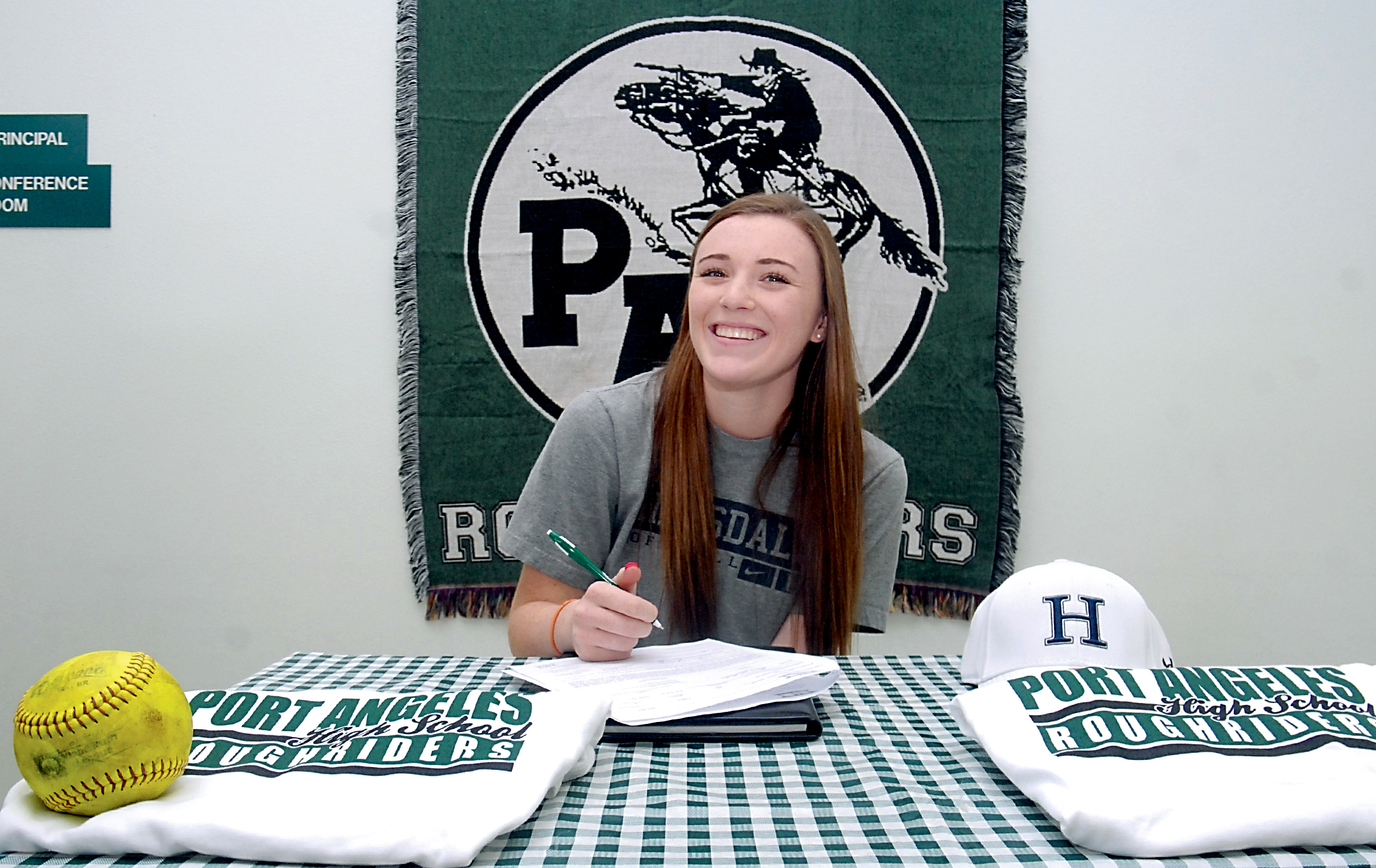 Port Angeles High School softball standout Carly Gouge signs a letter of intent to play at Hillsdale College in Hillsdale
