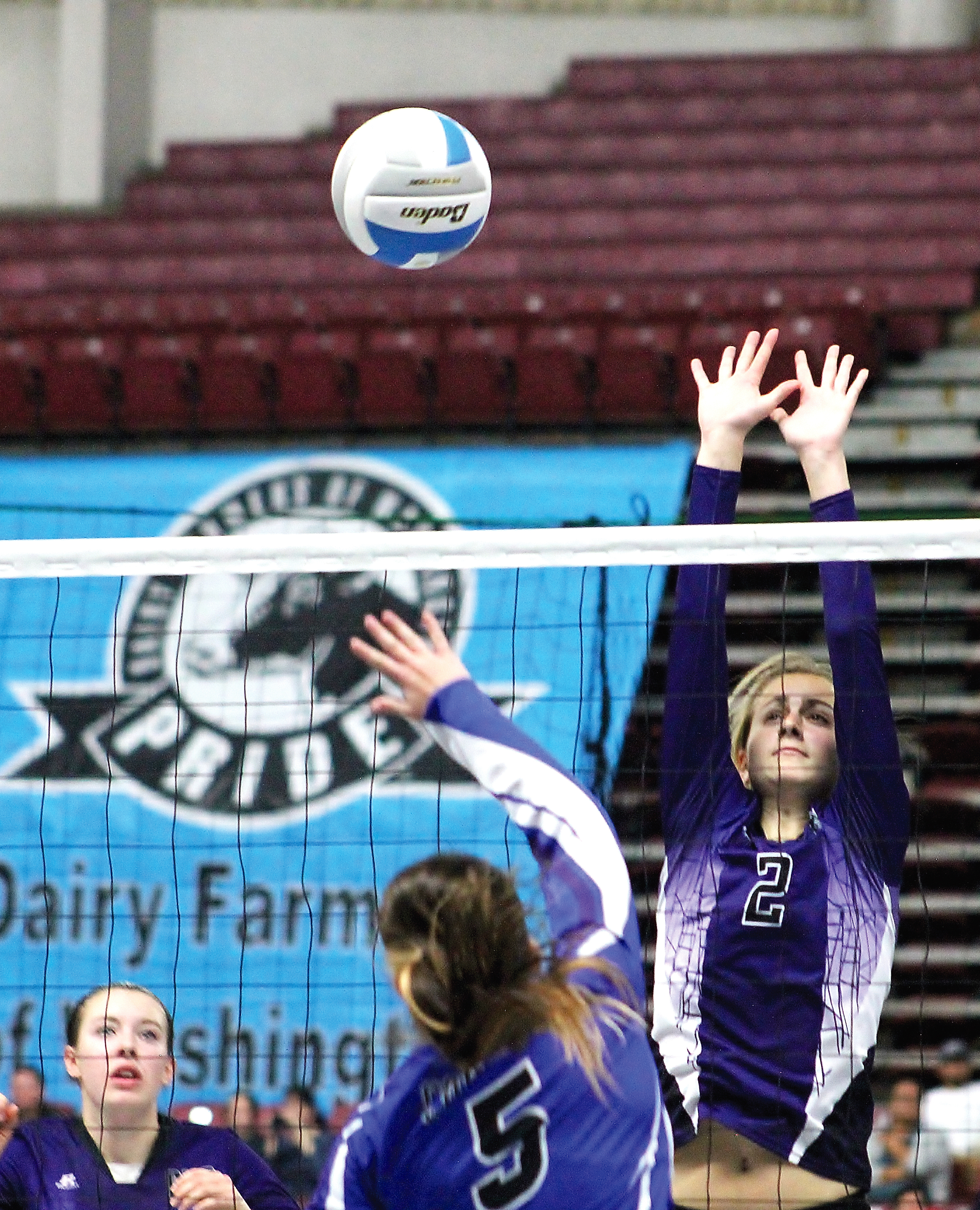 Quilcene's Katie Love (2) goes for a block against Lyle-Wishram's Winter Keeling-Bergin (5) as Quilcene's Megan Weller