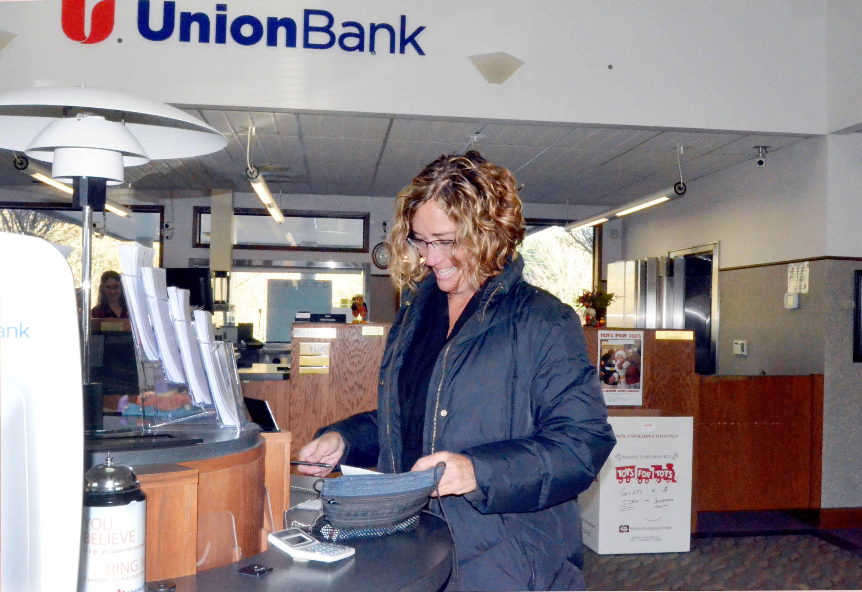 Barb Trailer of Port Townsend is one of the first customers for the business day at Port Townsend's Union Bank branch on Monday. The bank