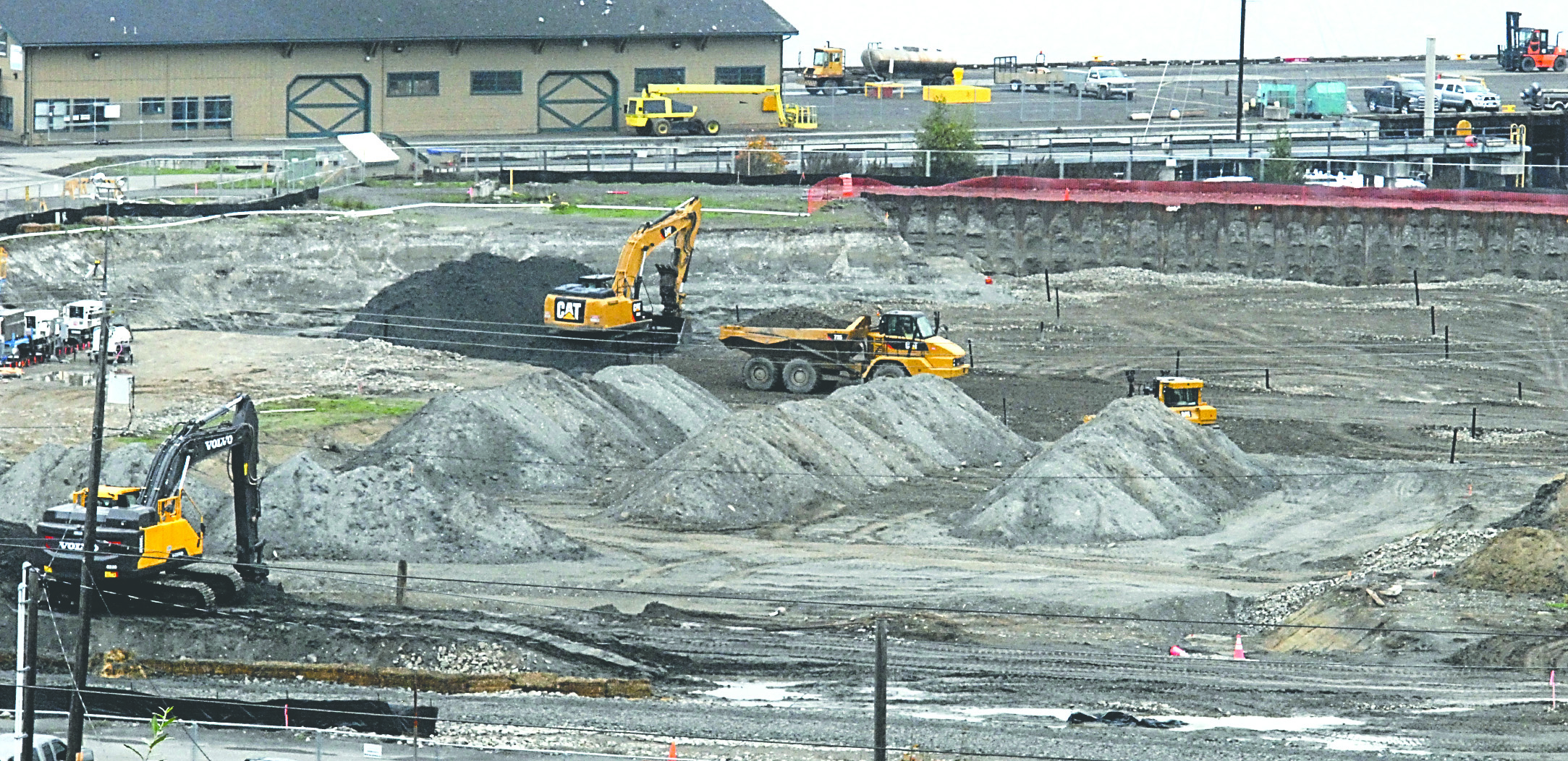Excavators and bulldozers remove dirt at the site of the former KPly mill in Port Angeles in October.
