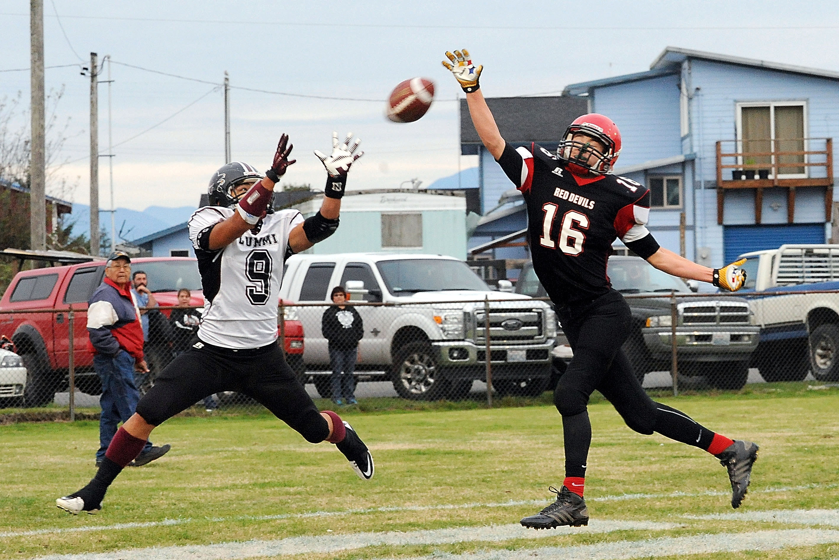 Neah Bay defensive back Cole Svec (16) attempts to knock down a pass intended for Lummi's Devin Cooper (9) during the Red Devils' 76-32 win over the Blackhawks in October at Neah Bay High School. Lonnie Archibald/for Peninsula Daily News