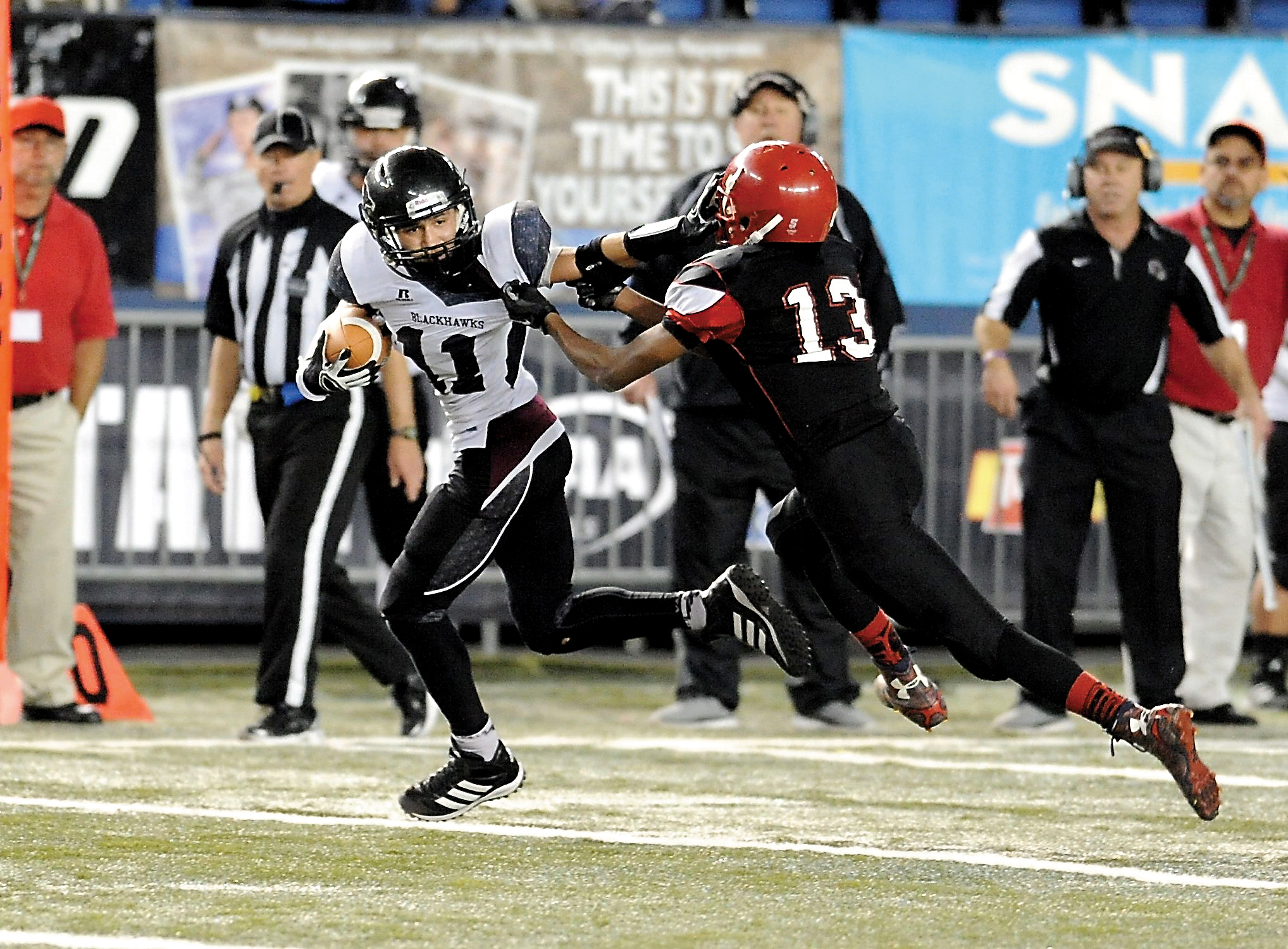 Lummi's Free Borsey (11) stiff-arms Neah Bay defender Anthony Bitegeko during the Blackhawks' 26-20 Class 1B state semifinal victory over the Red Devils at the Tacoma Dome. Borsey caught two first-half touchdowns for Lummi. Jeff Halstead/for Peninsula Daily News
