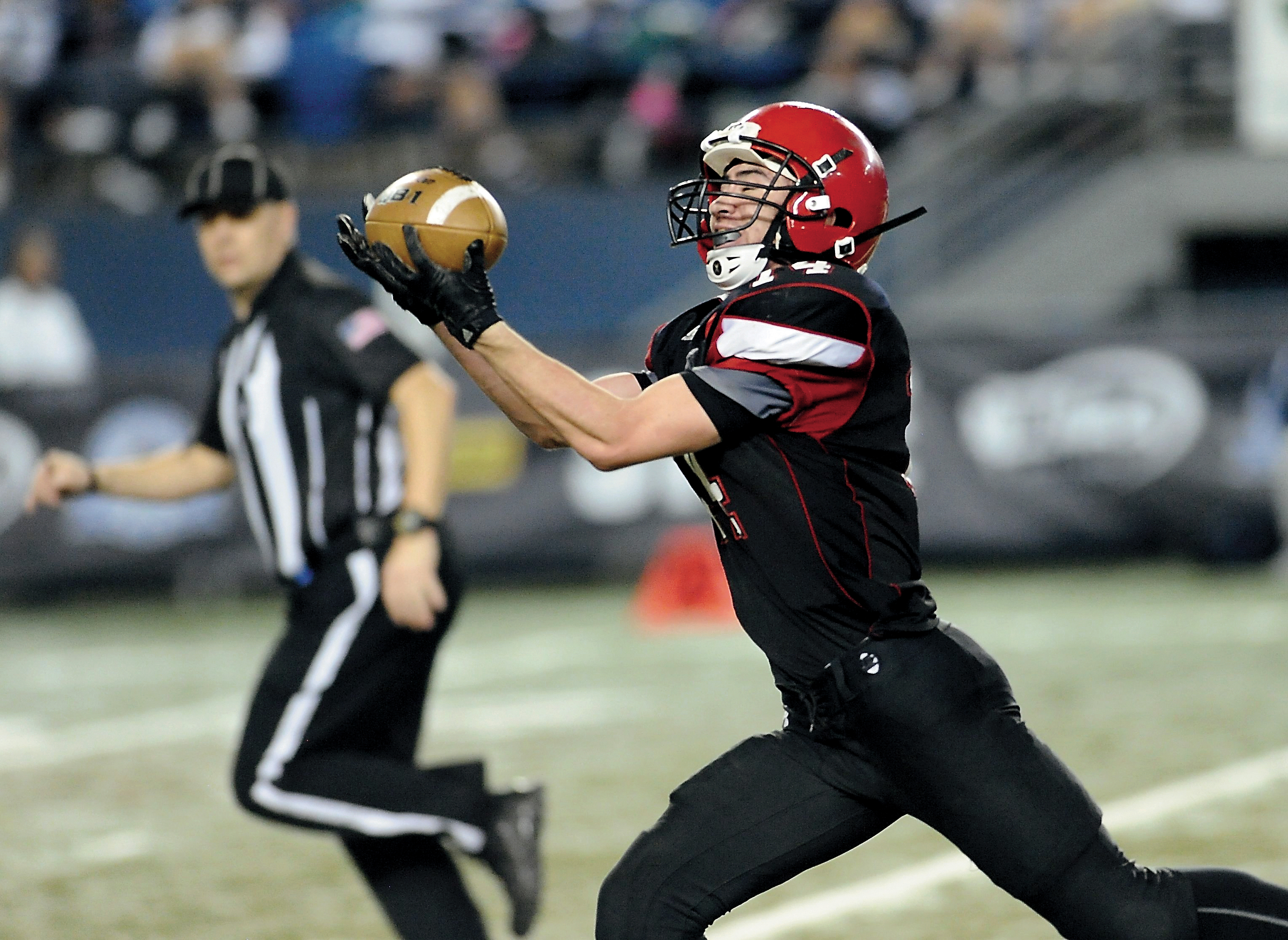 Neah Bay's Cameron Buzzell hauls in a fourth-quarter pass from Rwehabura Munyagi Jr. Buzzell scored a 60-yard touchdown on the play. Both Buzzell and Munyagi will return to the Red Devils next season. Jeff Halstead/for Peninsula Daily News