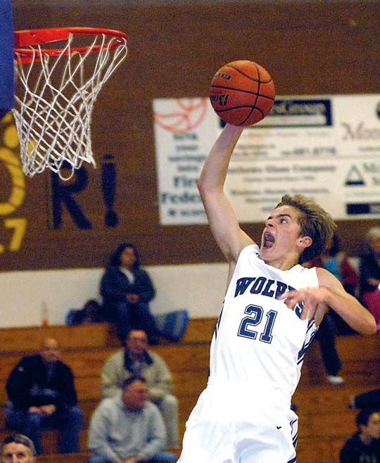 Sequim's Jackson Oliver soars for a slam dunk in the second quarter of the Wolves' 63-42 win over Klahowya. Oliver had 21 points to lead all scorers. Keith Thorpe/Peninsula Daily News