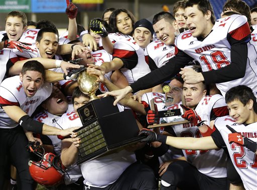 Neah Bay players celebrate with the trophy after they beat Touchet 36-18 in the Class 1B high school football championship game at the Tacoma Dome. Ted S. Warren/The Associated Press