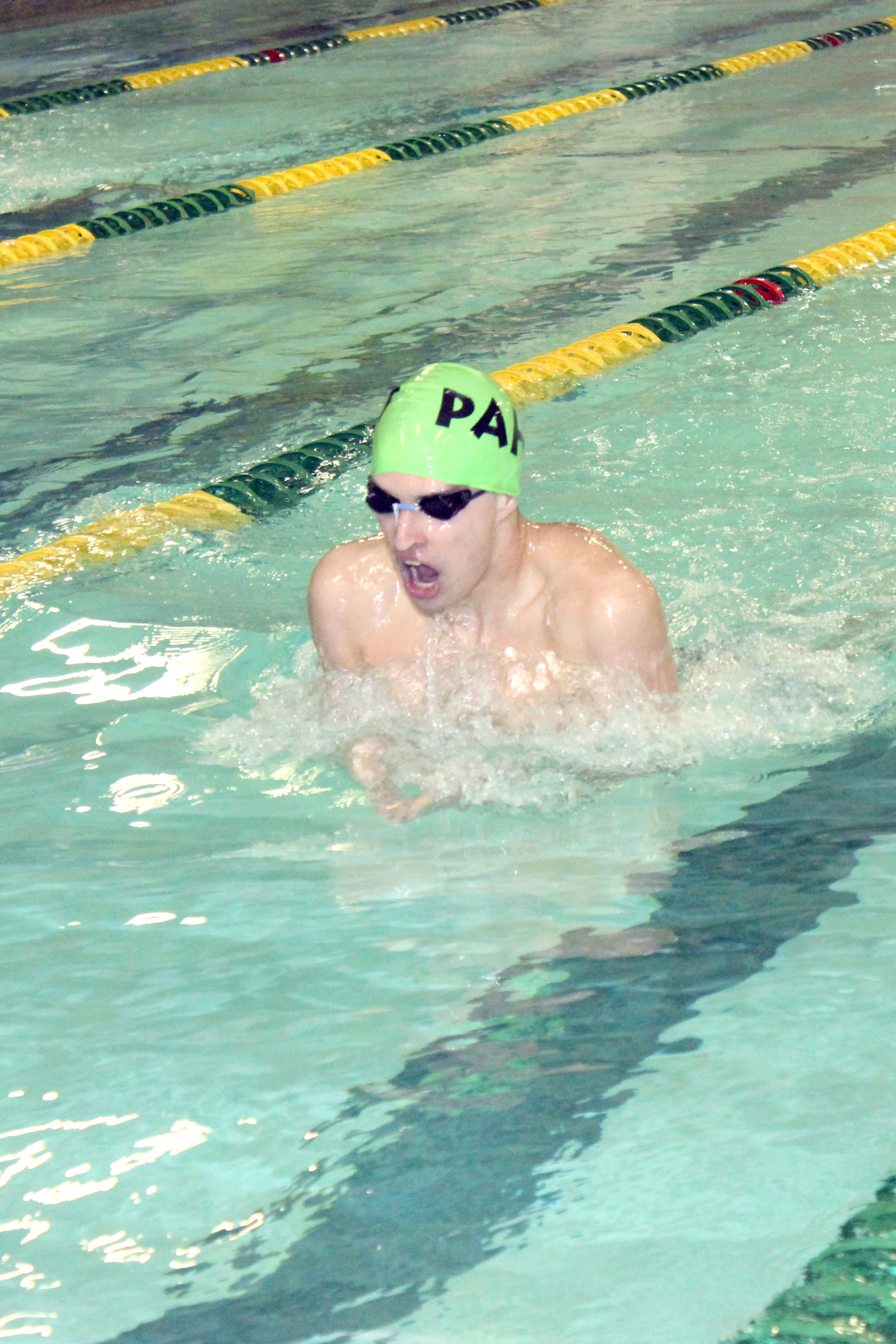 Port Angeles swimmer John Macias swam to state-qualifying times in 200 individual medley and 200 backstroke in the Roughriders' first home meet of the season.