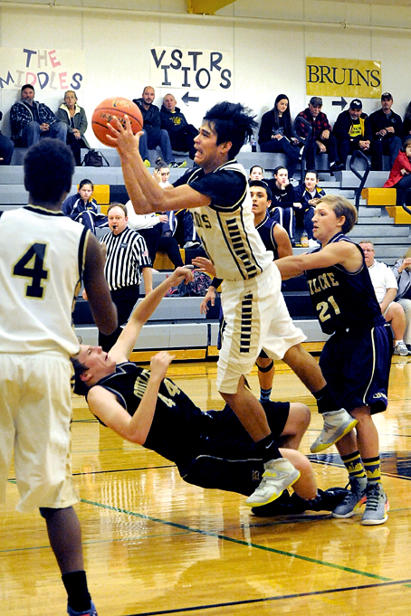 Clallam Bay's Alan Greene draws contact from Quilcene's Hayes Beathard (44) and Ben Bruner (21). Looking on are Clallam Bay's Jamari Signor (4) and Quilcene's Juan Rogers. Lonnie Archibald/for Peninsula Daily News